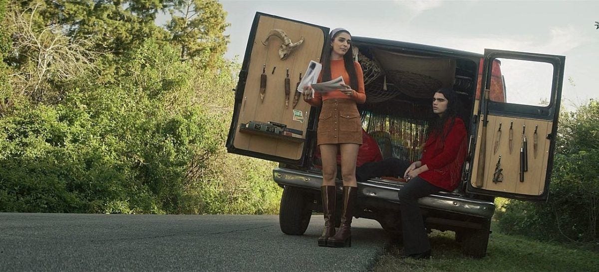 Wide shot of Lata and gay Carlos at back of van with lots of demon hunting tools on The Winchesters. Wide shot of Lata and gay Carlos at back of van with lots of demon hunting tools on The Winchesters.