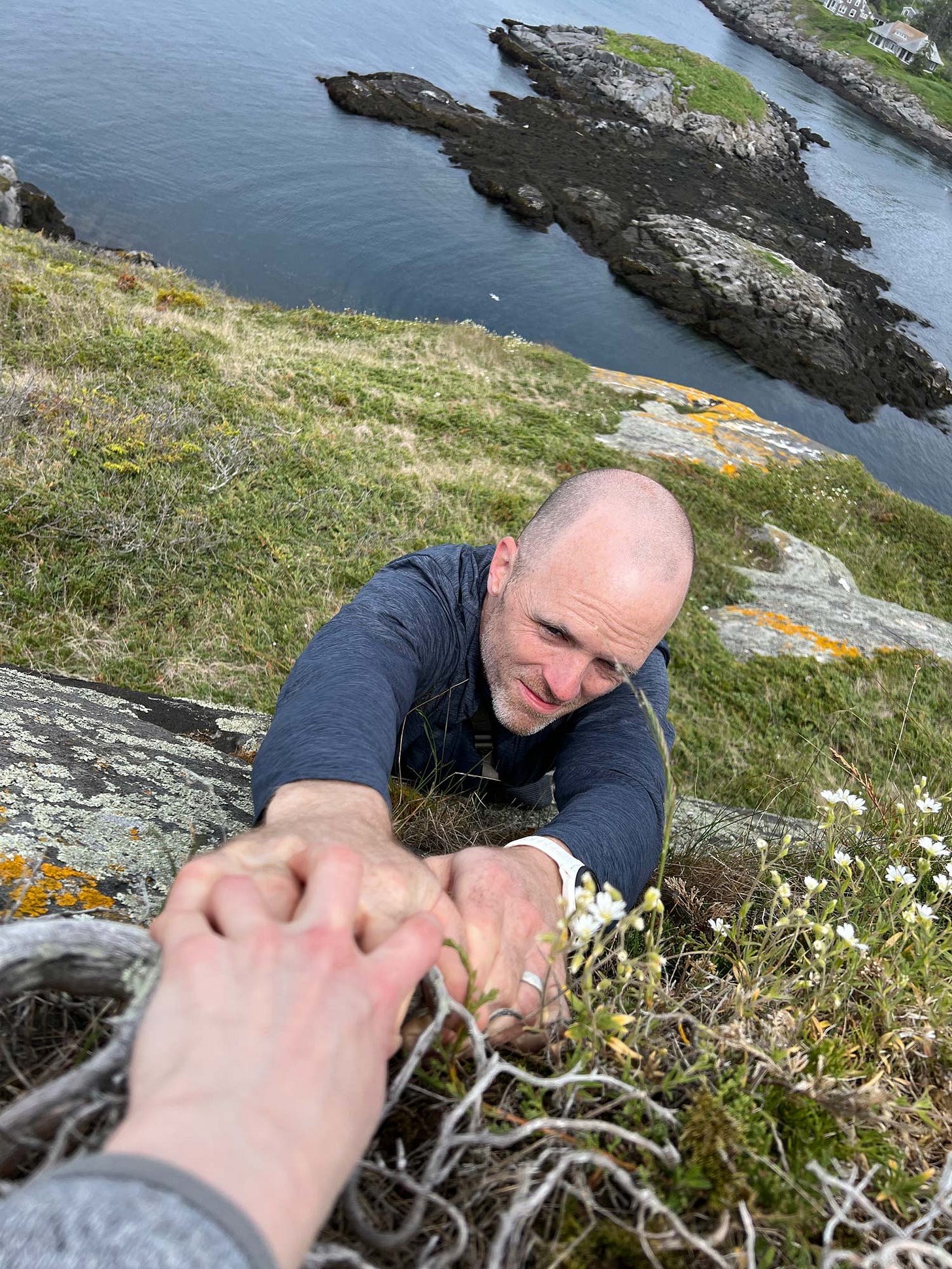 K. Woodman-Maynard, spouse , pretends to fall off a cliff to create reference photos for her upcoming graphic novel.