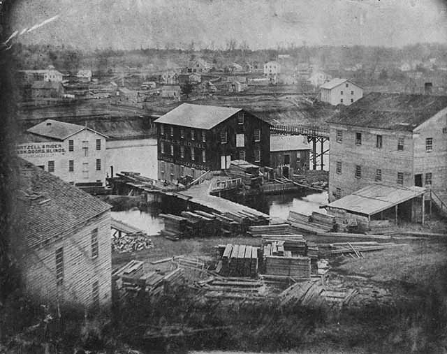 Old black and white photo of historic waterfront buildings at The History Museum. Old black and white photo of historic waterfront buildings at The History Museum.
