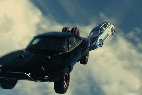 A still image from the Fast and Furious movies where two cars are falling through the air A still image from the Fast and Furious movies where two cars are falling through the air