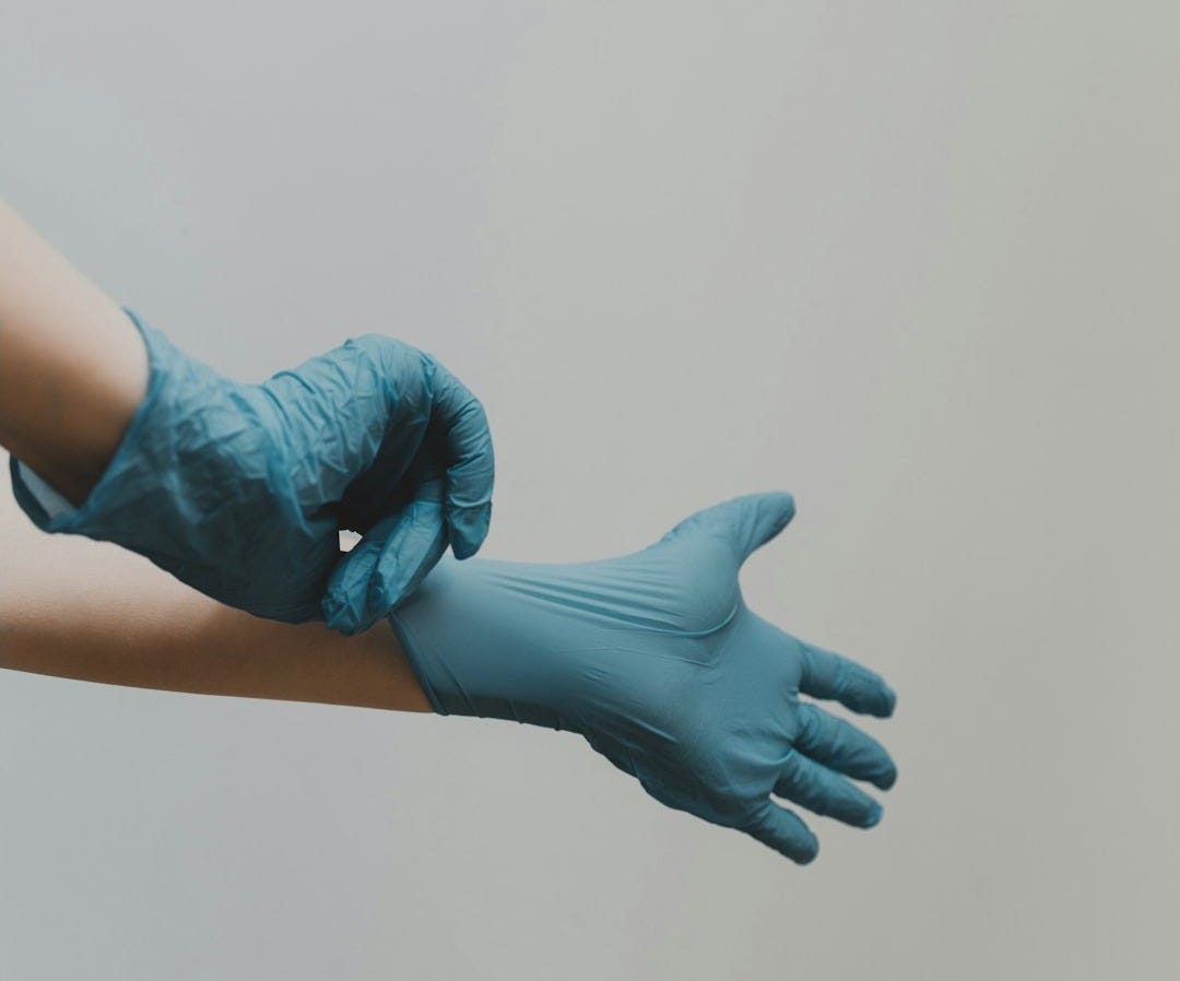 person in blue gloves and blue denim jeans person in blue gloves and blue denim jeans