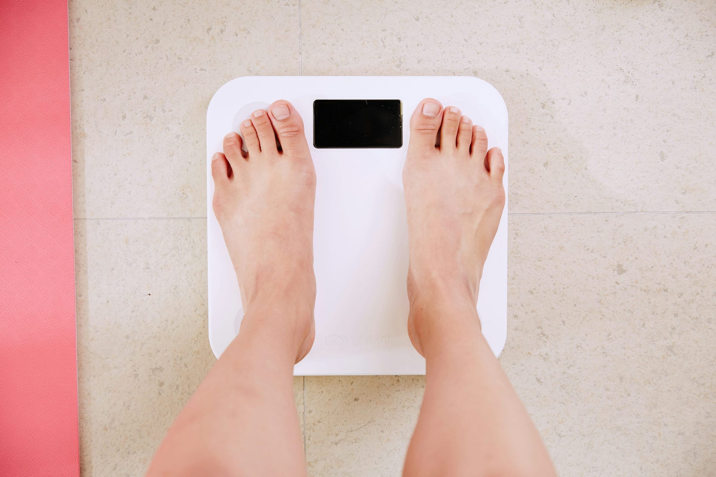 person standing on white digital bathroom scale