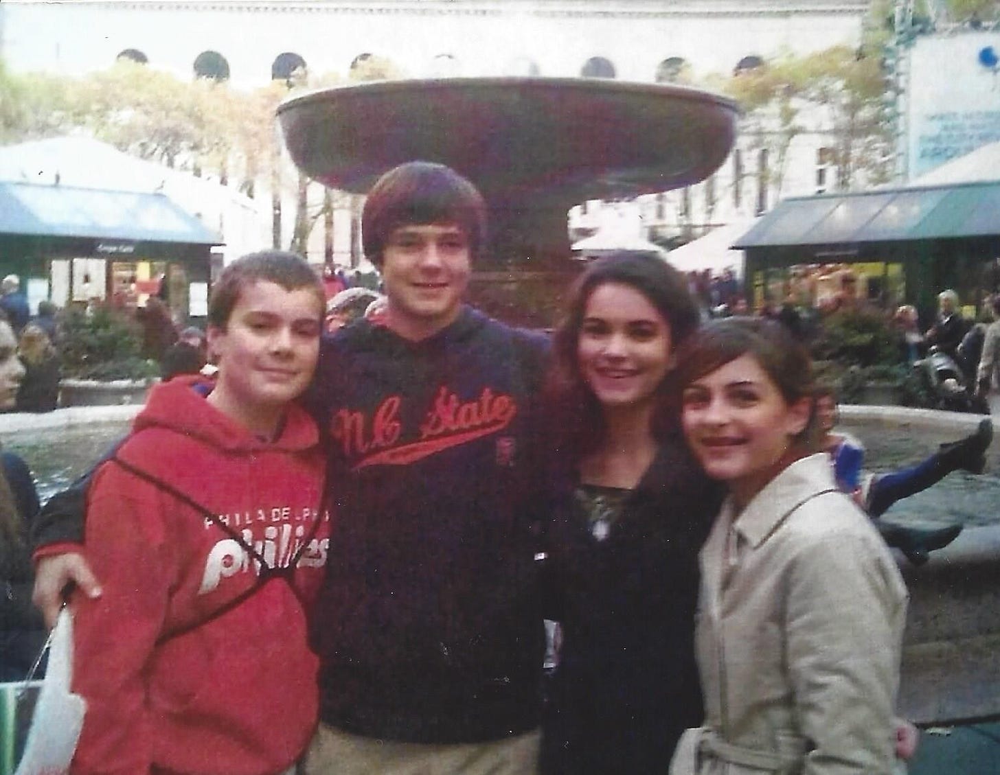 Two teen boy cousins posed alongside their two teen girl cousins in New York City