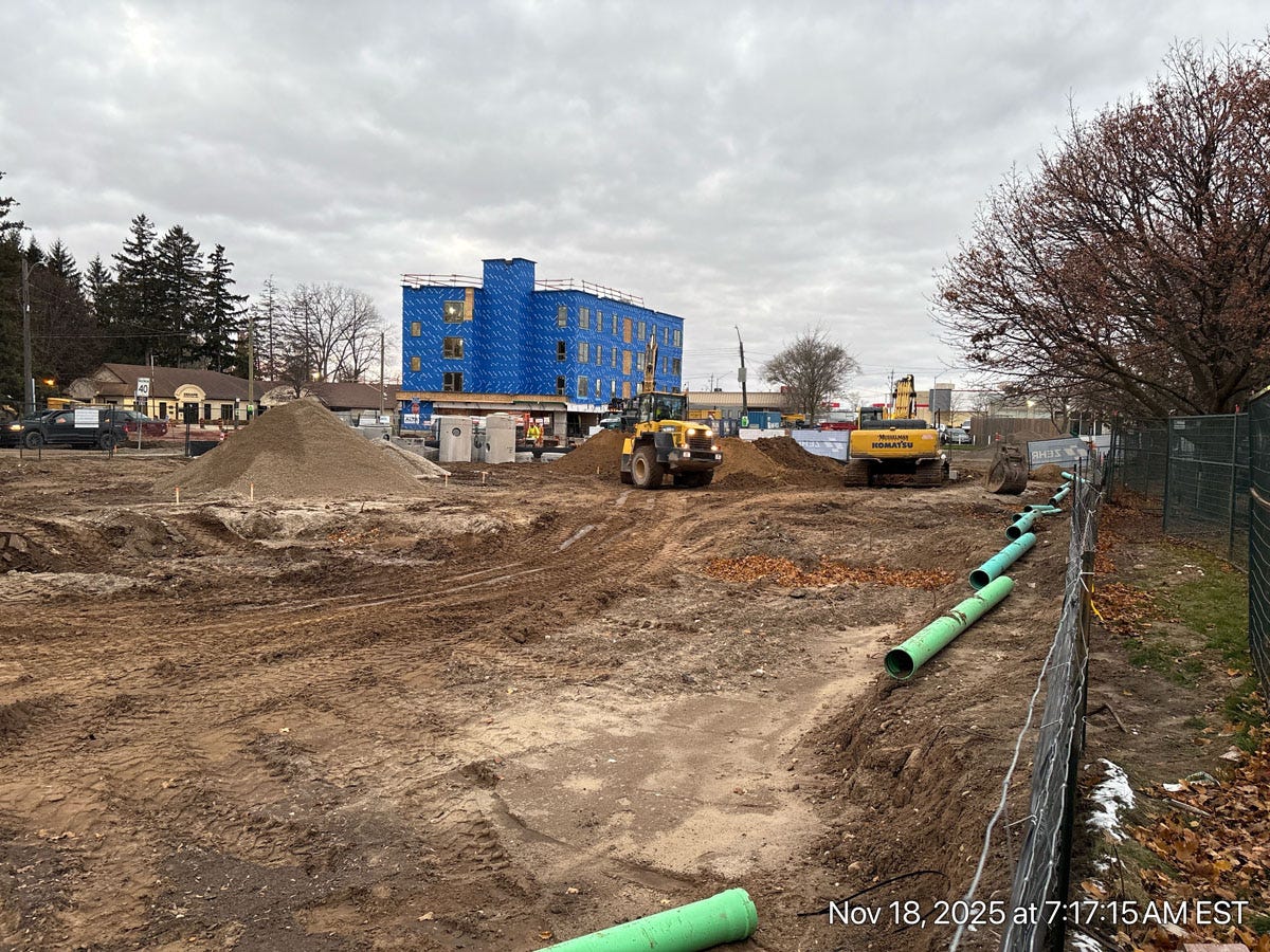Construction vehicles preparing the ground for a new affordable housing project