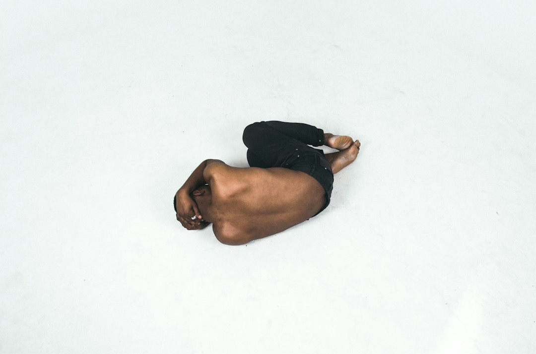 person lying down on white surface