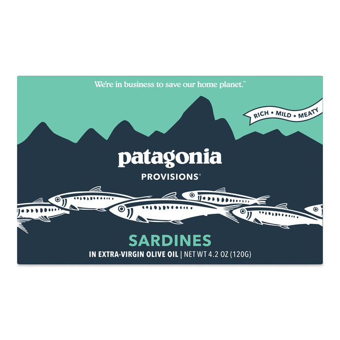 Rectangular package of Patagonia Provisions Sardines. The design features illustrated sardines, stylized mountains, and text: Rich • Mild • Meaty, Sardines in Extra-Virgin Olive Oil, and Net Wt 4.2 oz (120g). Rectangular package of Patagonia Provisions Sardines. The design features illustrated sardines, stylized mountains, and text: Rich • Mild • Meaty, Sardines in Extra-Virgin Olive Oil, and Net Wt 4.2 oz (120g).