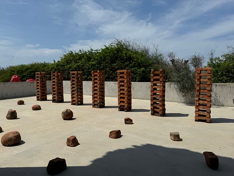 A gallery of images showing art by Bosco Sodi, mostly a collection of concrete and bricks.