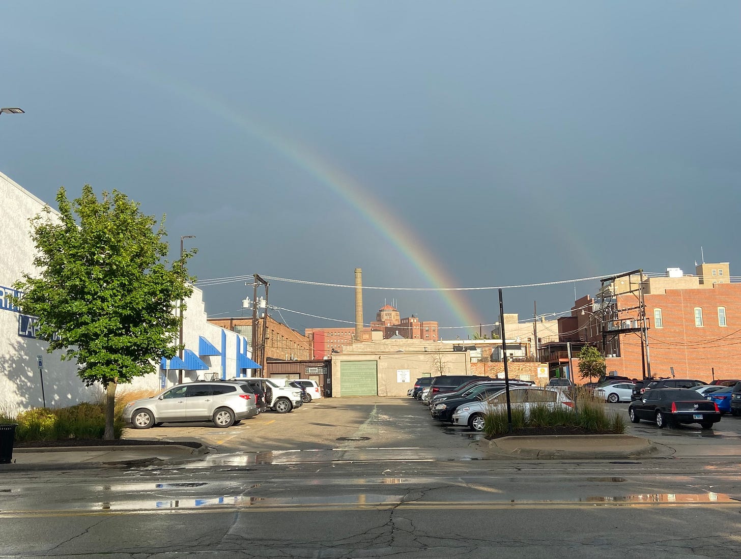 a rainbow in a dark sky over a parking lot in Rockford, IL a rainbow in a dark sky over a parking lot in Rockford, IL