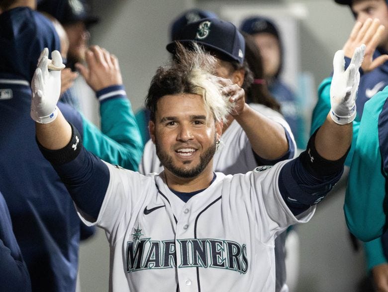 ­Eugenio Suarez celebrates his 2-run homer against the Houston Astros as Yohan Ramirez messes up his hair, April 15, 2022 in Seattle. (Dean Rutz / The Seattle Times)