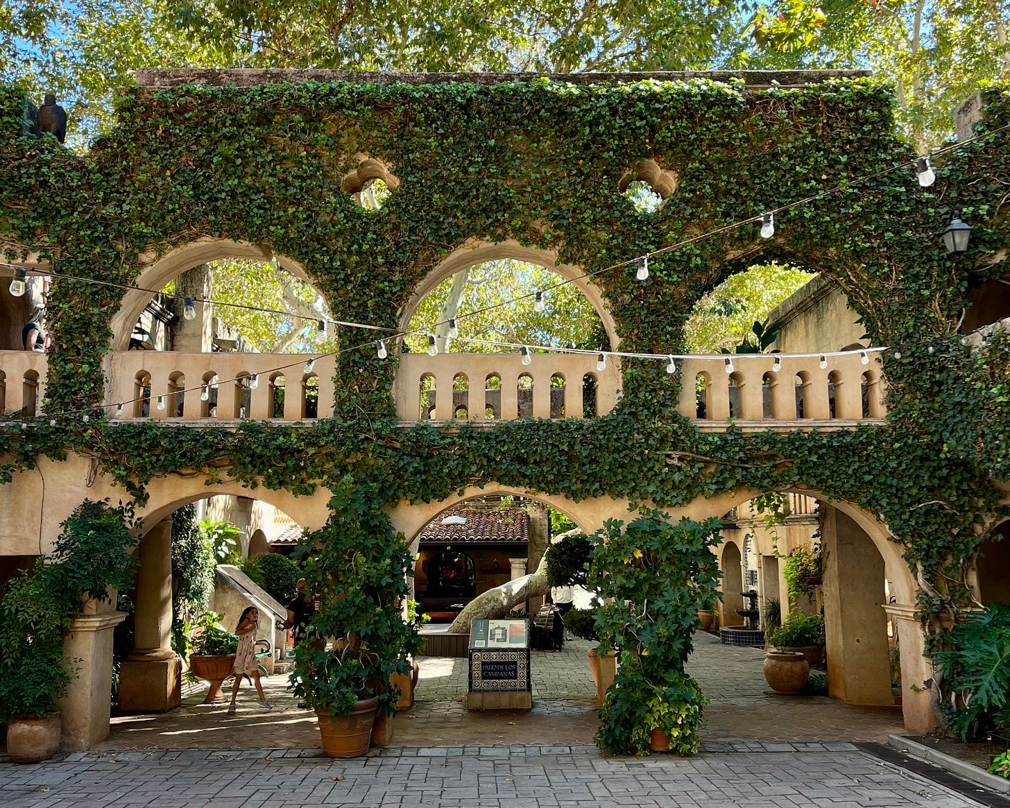 Spanish-style arches and cobblestone courtyards at Tlaquepaque Arts and Shopping Village, the heart of Sedona culture.