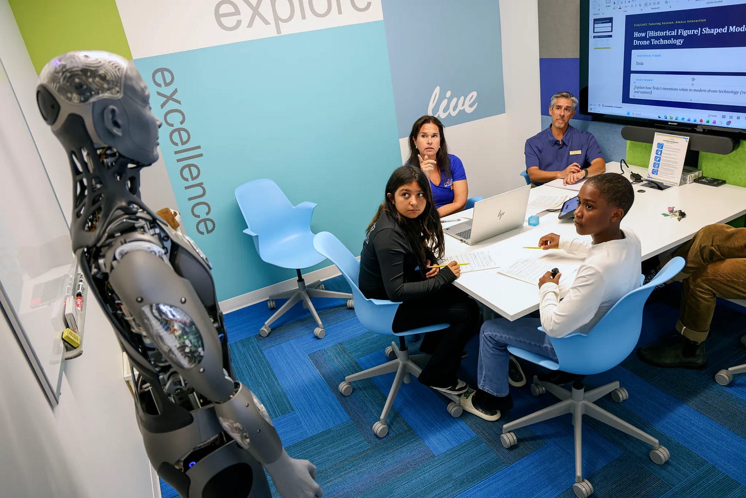 A picture of a robot in a classroom. Teachers and students look on quite skeptical.
