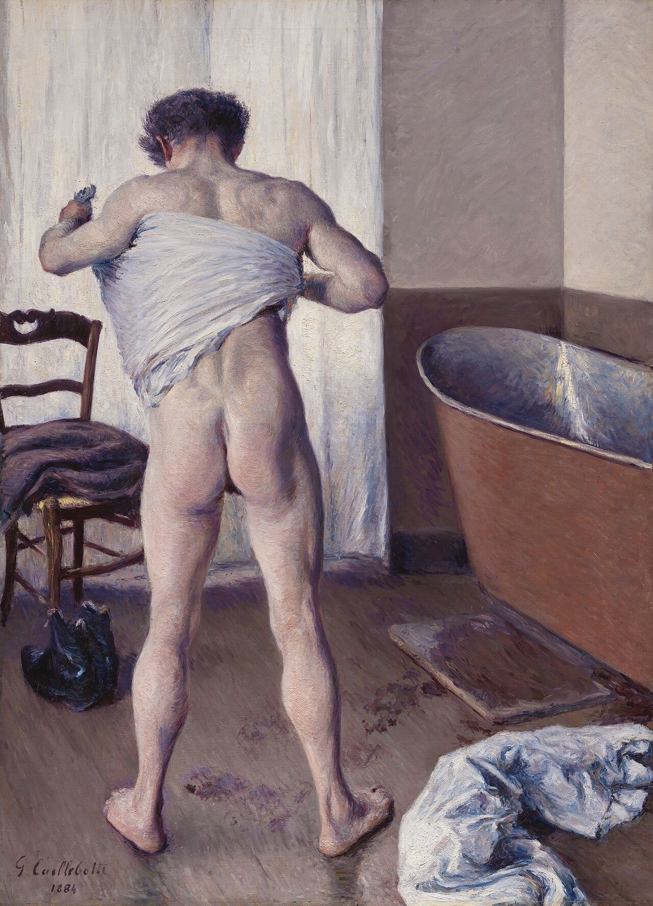 Man seen from behind drying himself with a towel Man seen from behind drying himself with a towel