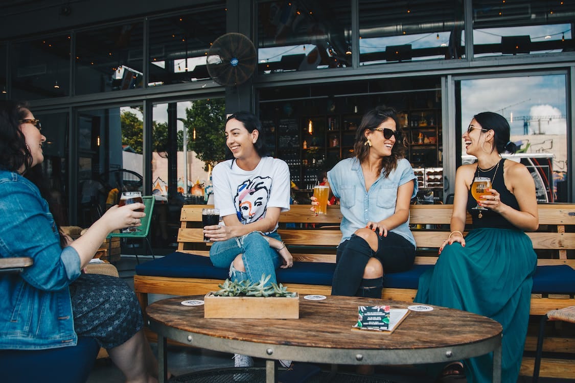 Free Four Women Sitting on Benches Outside Building Stock Photo Free Four Women Sitting on Benches Outside Building Stock Photo