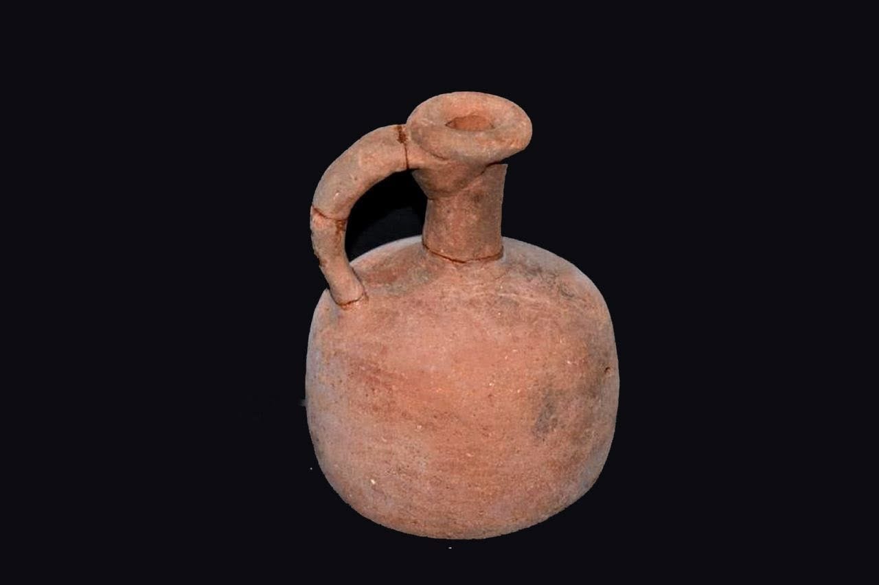 A well-preserved ceramic jug with a handle, recovered from the excavation, reflecting everyday domestic pottery traditions at the site.