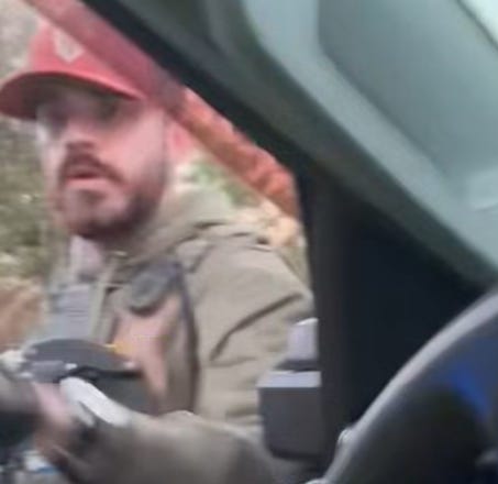 ICE Agent orders Atilio Portillo to exit his truck after breaking out a side window.  (Frame grab from video released by Siembra NC)