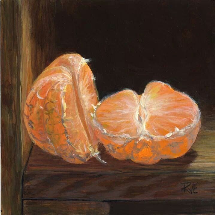 This may contain: an orange cut in half sitting on top of a table