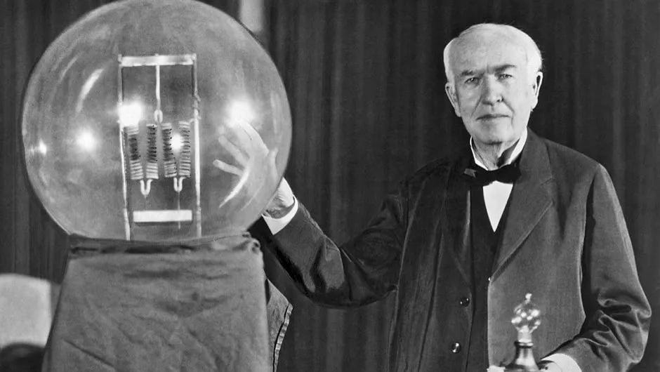 Thomas Edison with a giant lightbulb