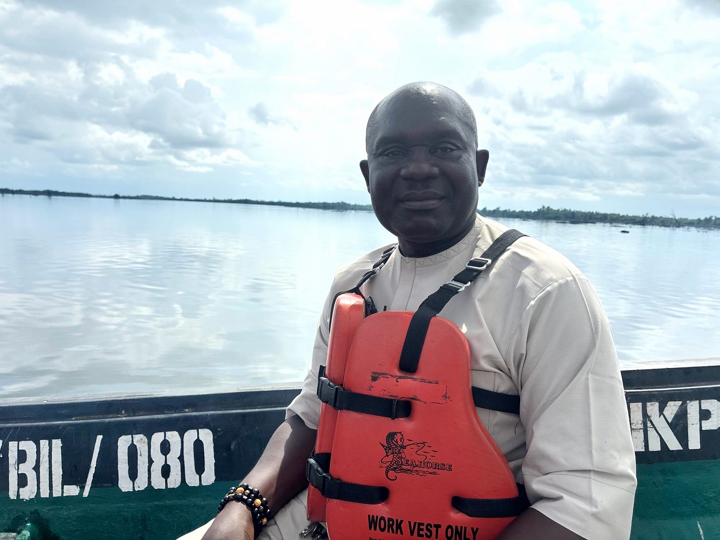 Chief Boma Renner Dappa, the spokesperson for the Bille local leaders' council, on a boat in a lifejacket