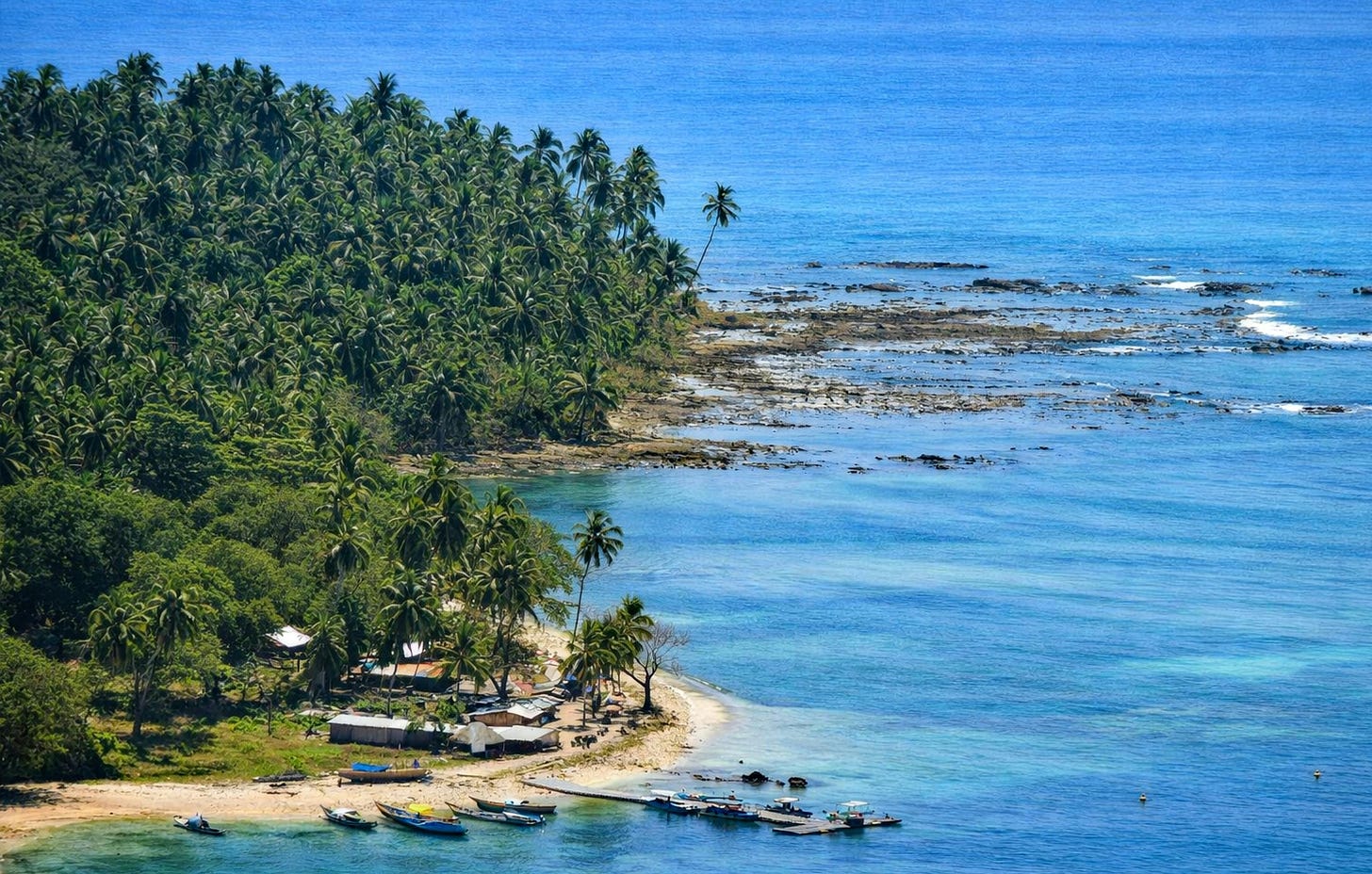 coastline showing a small marina with small fishing boats coastline showing a small marina with small fishing boats