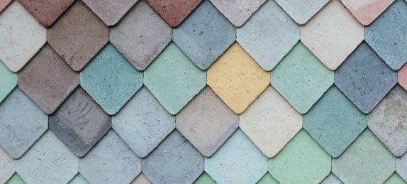 a multicolored tile wall with a pattern of small squares