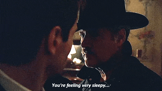 Alex Trebek, wearing a cowboy style hat, says to Mulder "You're feeling very sleepy...very relaxed." Alex Trebek, wearing a cowboy style hat, says to Mulder "You're feeling very sleepy...very relaxed."
