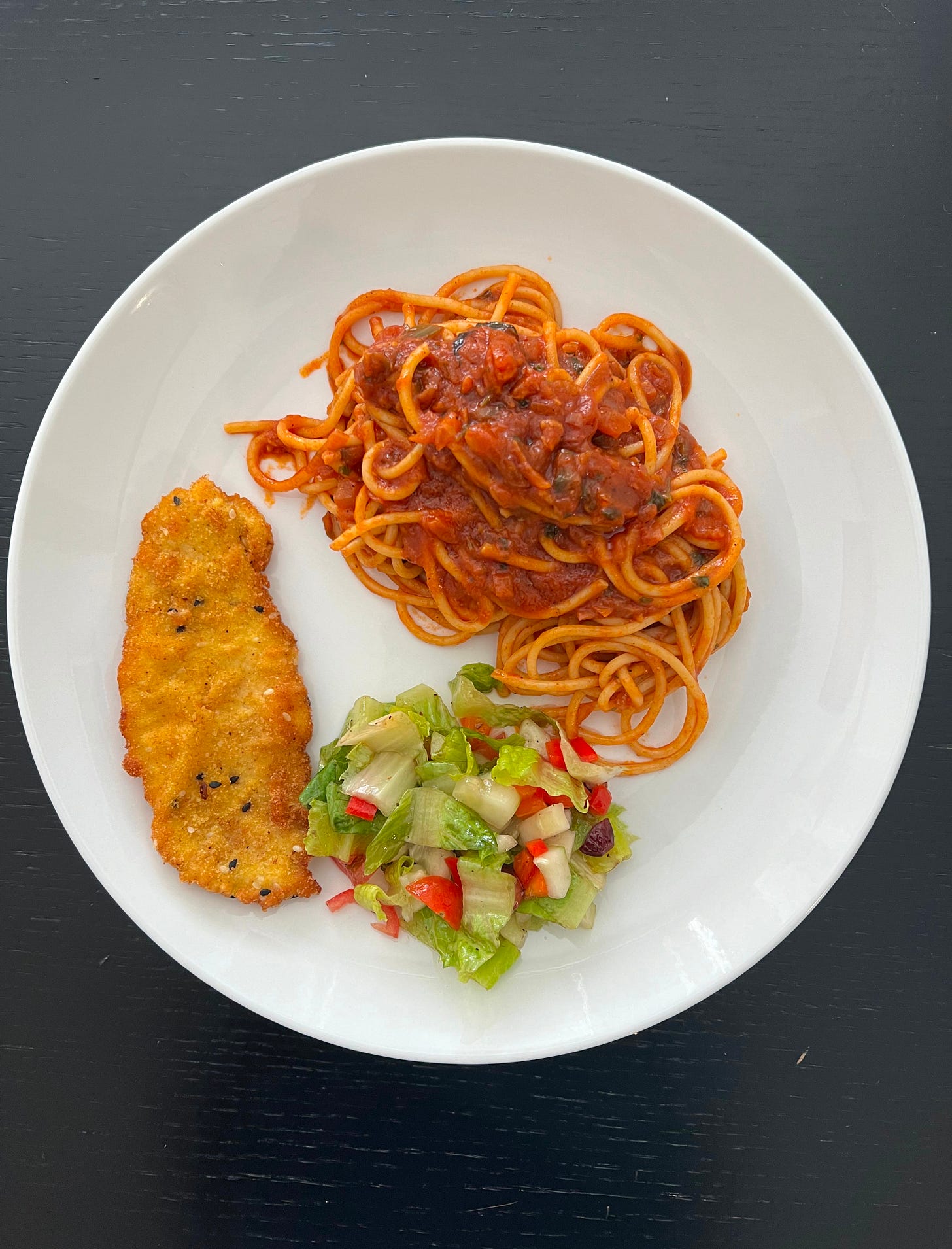 A crispy, golden schnitzel served alongside a generous helping of spaghetti coated in a rich tomato sauce, paired with a fresh salad of crisp lettuce and diced vegetables. This plate exemplifies Liat Portal's love for comforting, home-cooked meals, central to her Foodie Disorder series on The Liat Show. A crispy, golden schnitzel served alongside a generous helping of spaghetti coated in a rich tomato sauce, paired with a fresh salad of crisp lettuce and diced vegetables. This plate exemplifies Liat Portal's love for comforting, home-cooked meals, central to her Foodie Disorder series on The Liat Show.