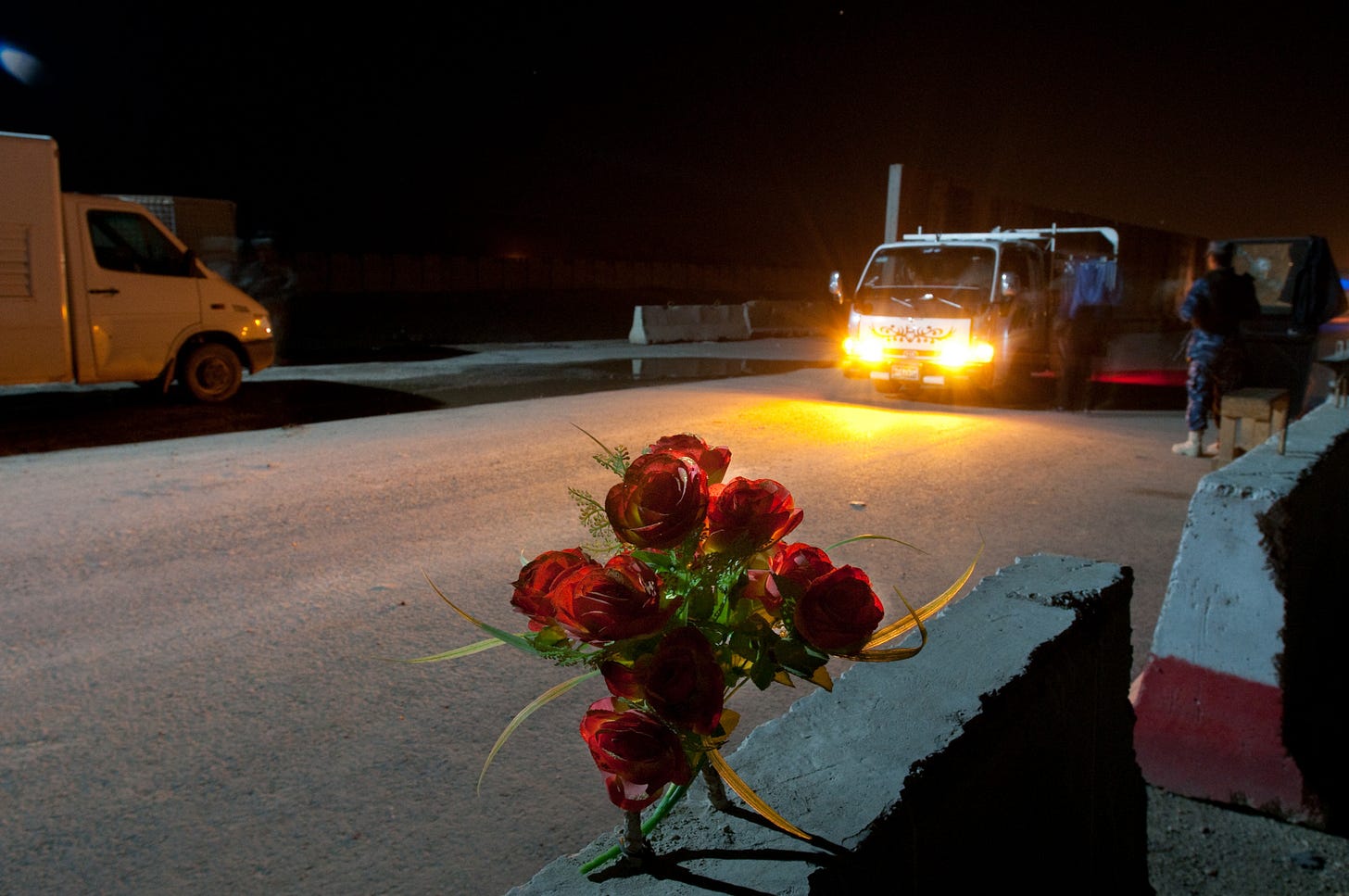 An Iraqi policeman checks the identification of a truck driver passing through a traffic control point between Baghdad and Al Anbar province, Iraq, Nov. 22, 2009. Vehicle-scanning explosives detection equipment deployed by paratroopers of Company A, 2nd Battalion, 504th Parachute Infantry Regiment, 1st Brigade, 82nd Airborne Division (Advise and Assist Brigade), checks the cargo of passing vehicles for arms and explosives, making inspections safer for Iraqi security forces, increasing security and minimizing delay to Iraqis. 