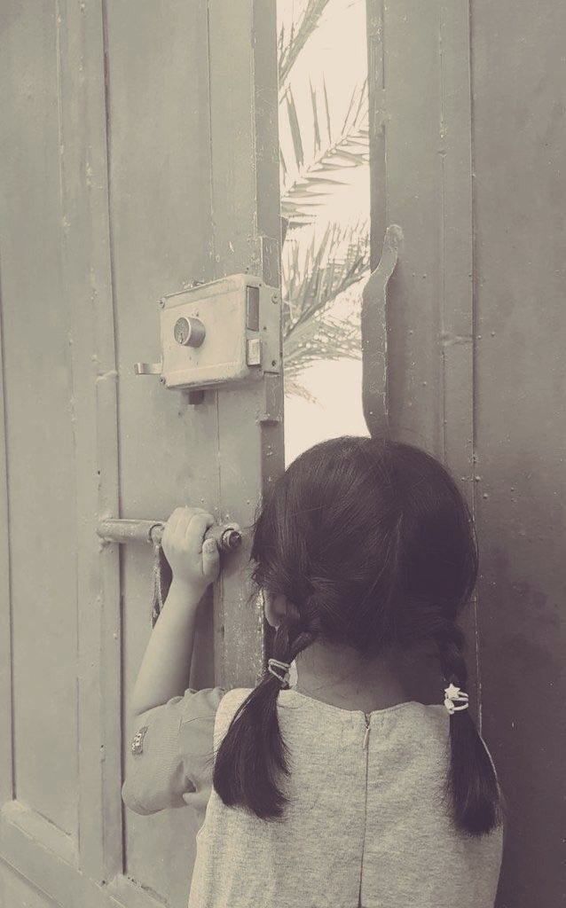 May be a black-and-white image of child and light switch