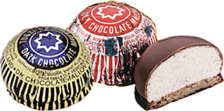 Tunnocks Teacake Three Tunnocks Teacake, two wrapped in silver foil one half eaten