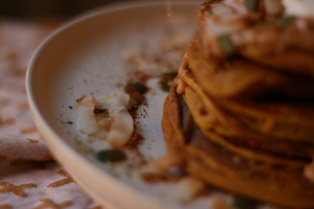 These pancakes are made with pumpkin puree, oats blended into out flour, an egg, and very little else.
