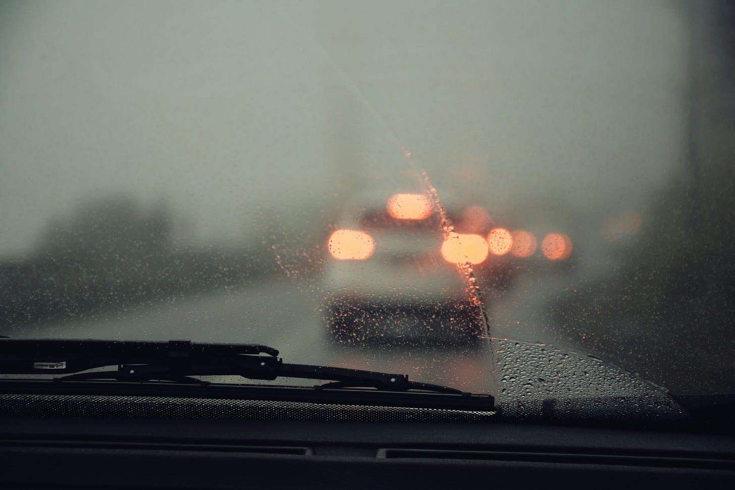 rainy car window in traffic rainy car window in traffic