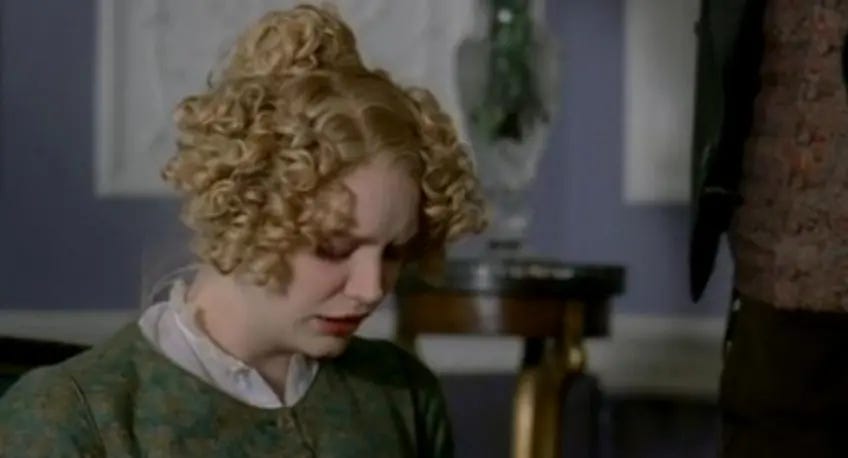 Harriet Smith has her head bowed in sadness. 