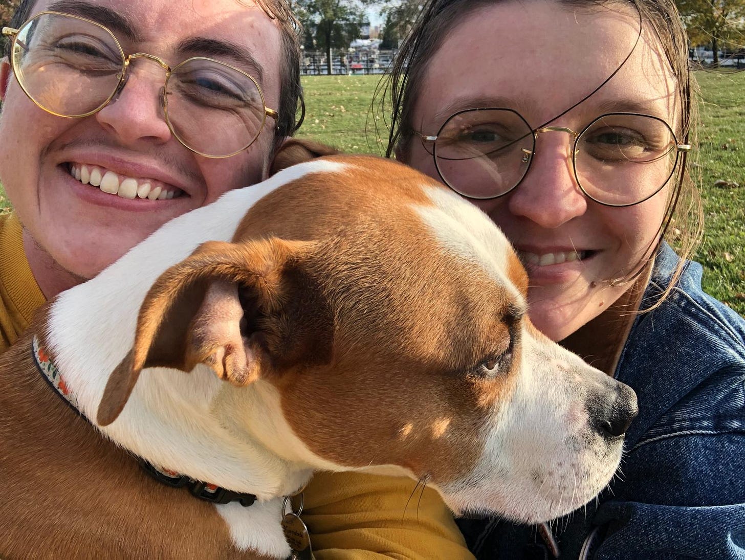 Emory and Jo smile for a selfie while Marmalade stubbornly stares in a different direction, refusing the attention of the paparazzi