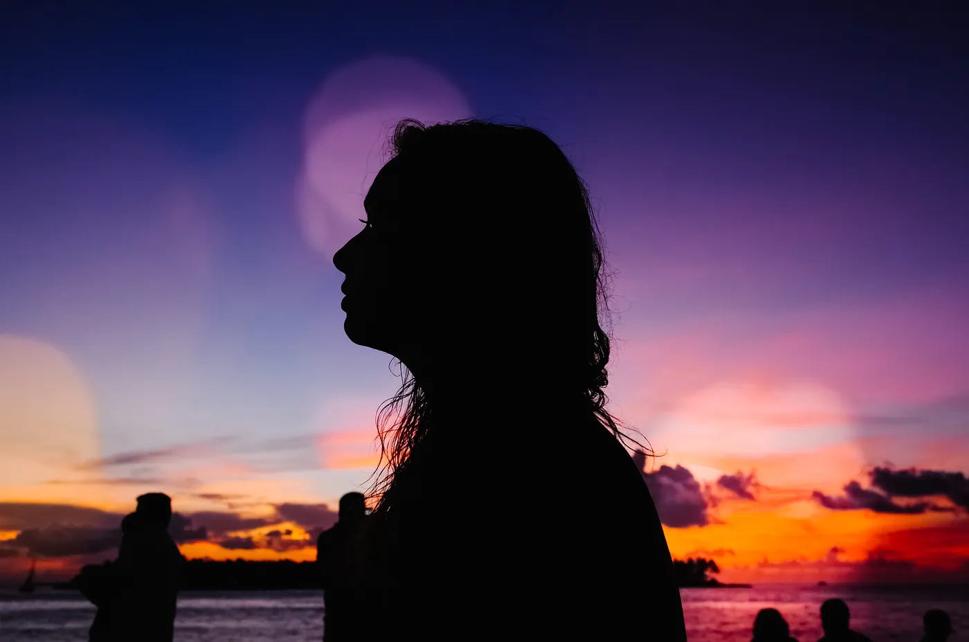 Beautiful long haired woman at sunset on the beach Beautiful long haired woman at sunset on the beach