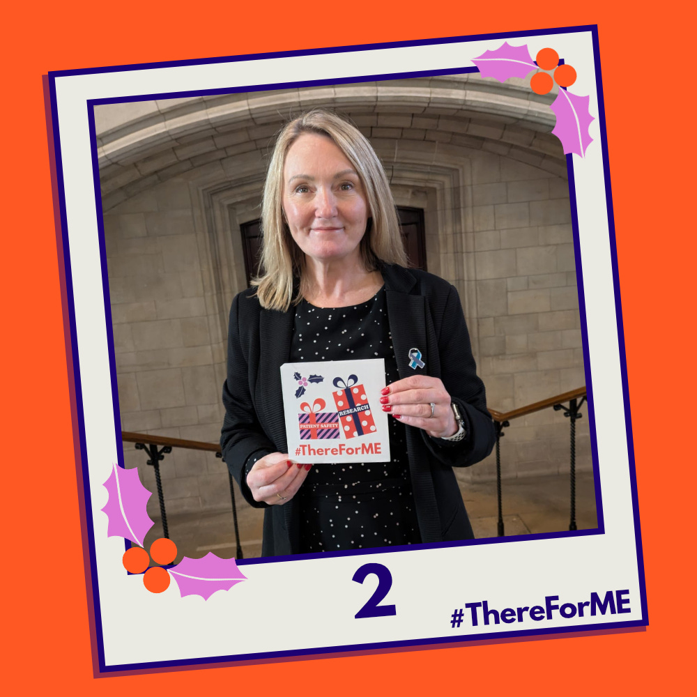 A pretend polaroid shows Jo Platt MP posing for a photo holding a #ThereForME Christmas card.   The image on the card shows two presents, one labelled "patient safety", the other "research". The photo is labelled "2". The design is in the #ThereForME colours.