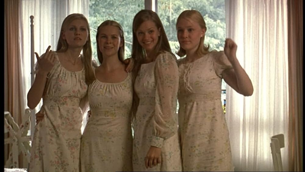 The Lisbon sisters posing for a photo in their prom dresses.