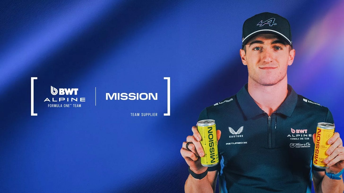 An off-centre promotional shot of Jack Doohan. He's wearing blue team kit and cap, and holding up two cans of "Mission" beverage, a new team sponsor. He is showing the weakest attempt at smiling I have ever seen. An off-centre promotional shot of Jack Doohan. He's wearing blue team kit and cap, and holding up two cans of "Mission" beverage, a new team sponsor. He is showing the weakest attempt at smiling I have ever seen.