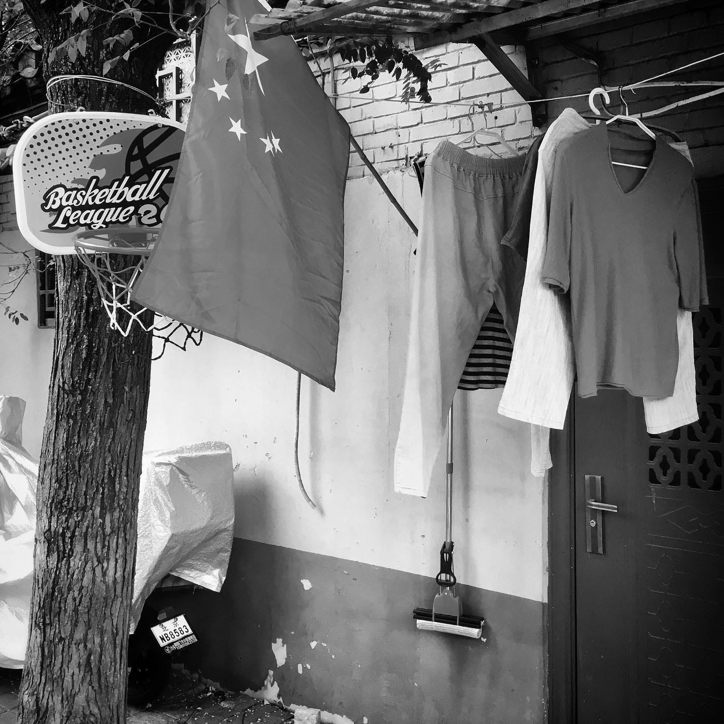 National flag hanging outside a house in a Beijing hutong.