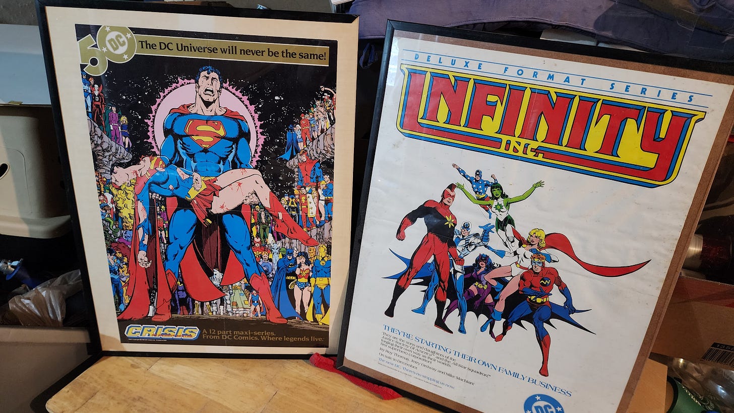 A photo of 2 of Naladahc's favorite comic promo posters he's kept: "Crisis on Infinite Earths" #7 advert and a poster for the debut of "Infinity, Inc."