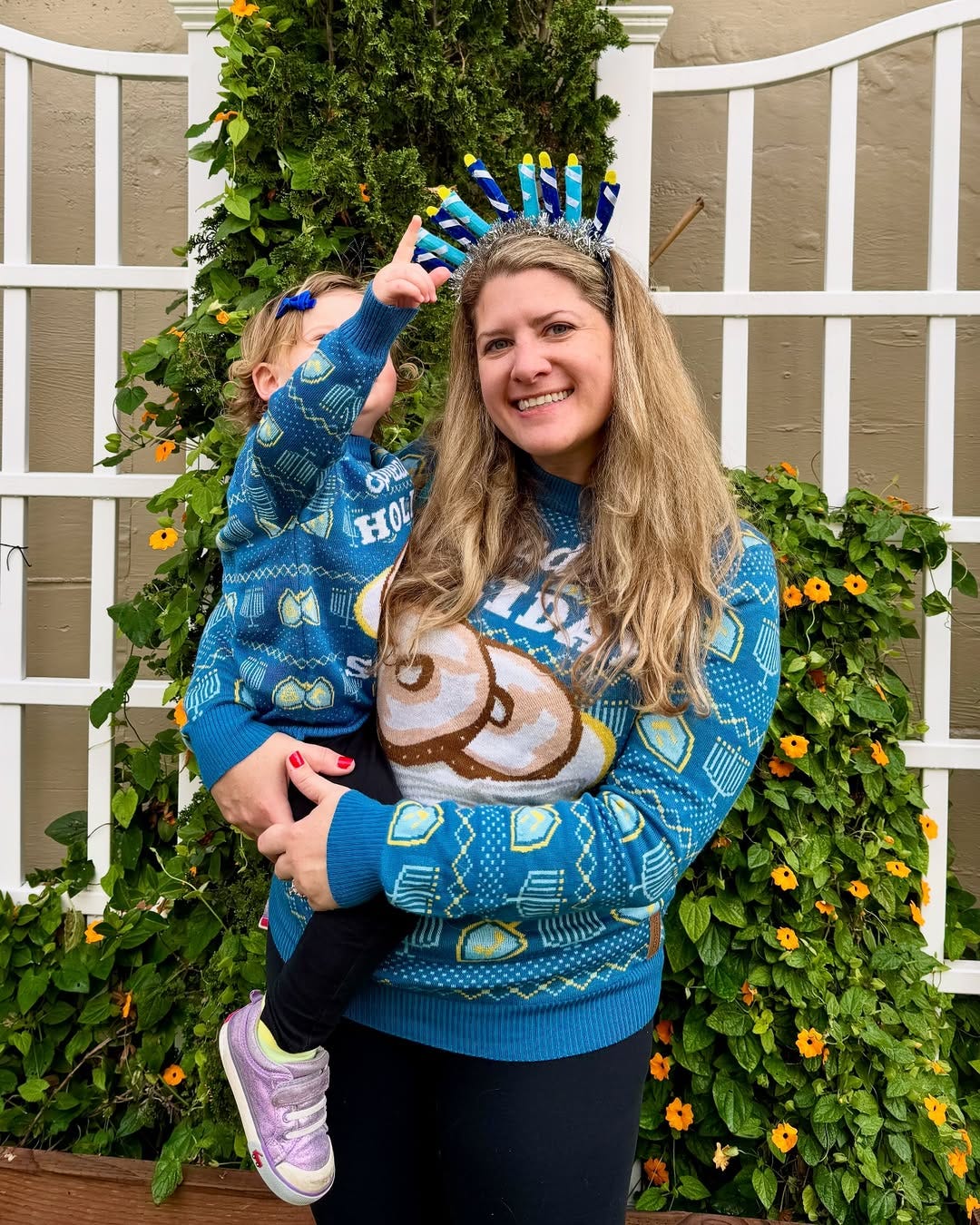 Amy Becker and her daughter wearing matching blue sweaters