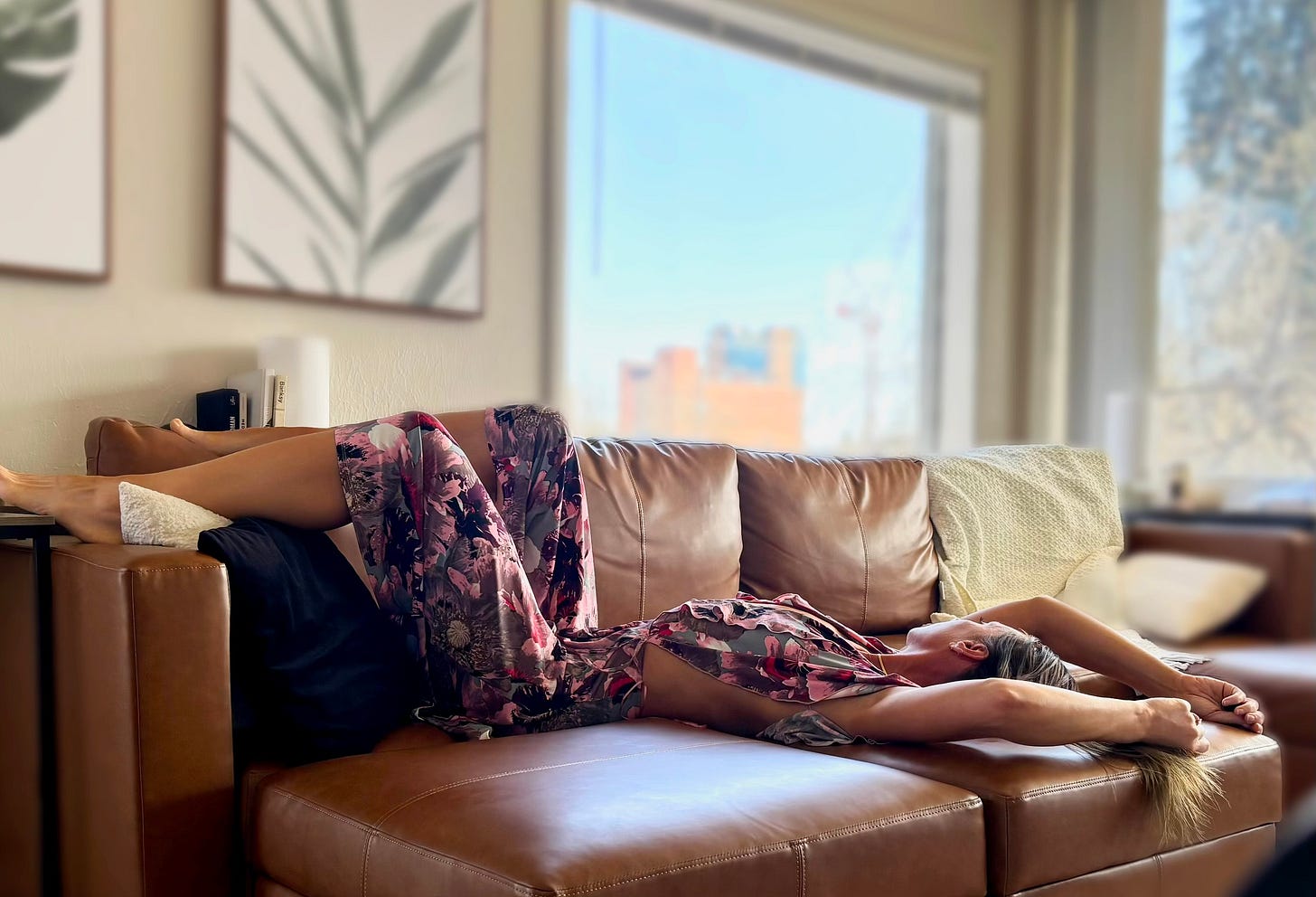 woman laying on couch bored