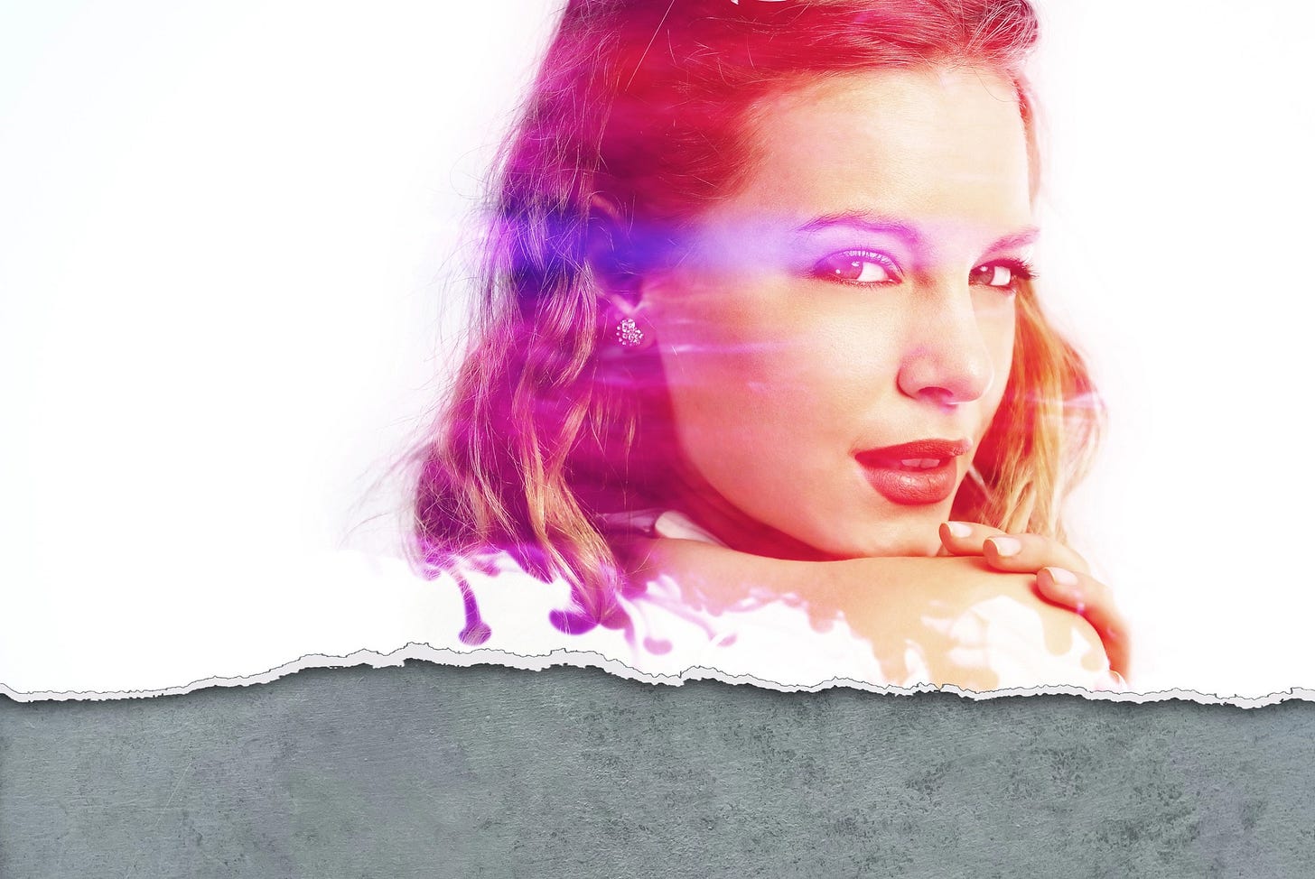 Close-up of a young woman looking over her shoulder directly at us