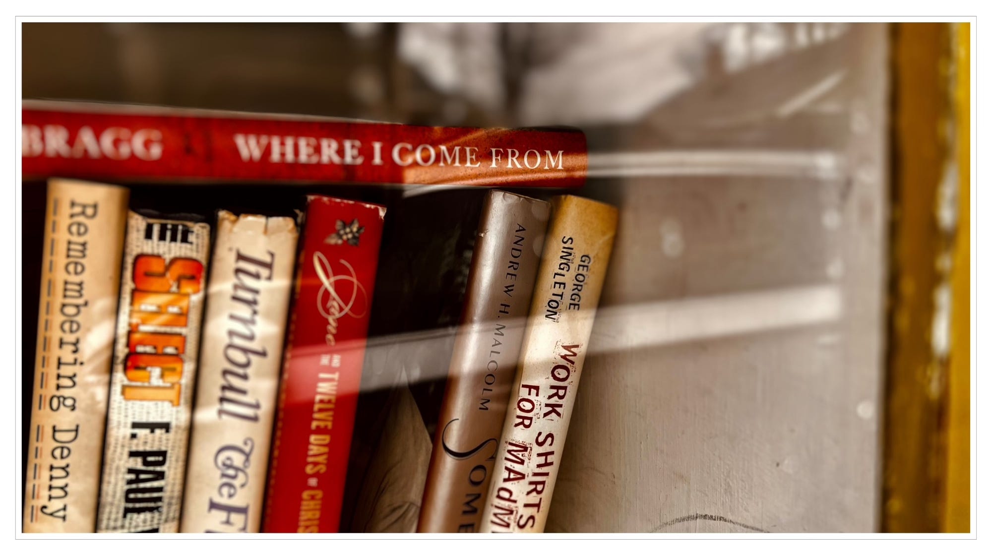 close-up of stack of books behind glass door
