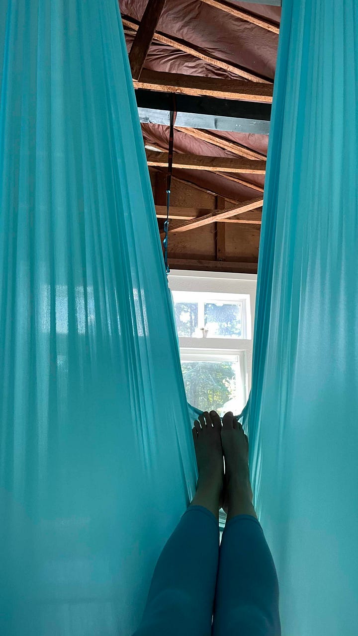 Image 1- 3 magenta flower blooms hanging with moisture on the stamen; image 2- feet extended in a teal anti-gravity hammock