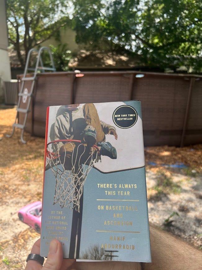 Photo of a book called There's Always This Year with an above-ground swimming pool in the background.