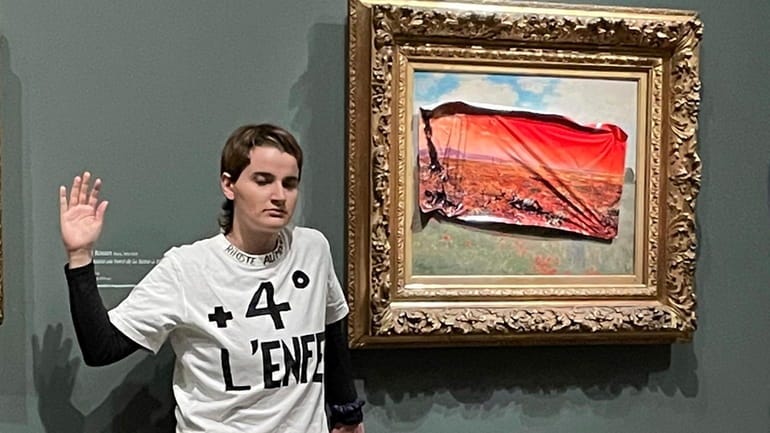 A climate activist in Paris stuck a protest poster on Monet's 'Poppy Field' - Newsday A climate activist in Paris stuck a protest poster on Monet's 'Poppy Field' - Newsday