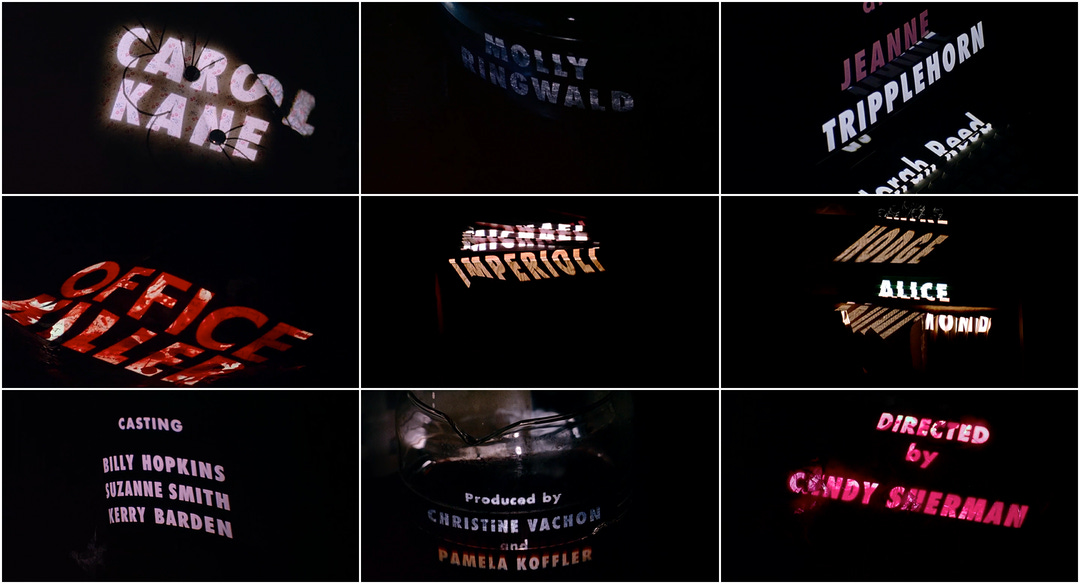 A grid of 9 images featuring the title sequence from the movie, Office Killer, which features the credits being projected onto various office supplies, in the dark.