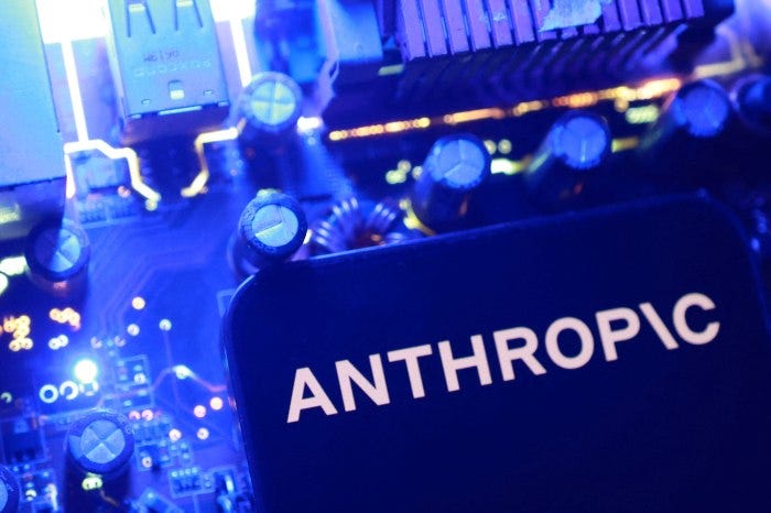 Illustration of the Anthropic logo on a dark screen, set against a blurred background of blue-lit circuit board components. Illustration of the Anthropic logo on a dark screen, set against a blurred background of blue-lit circuit board components.