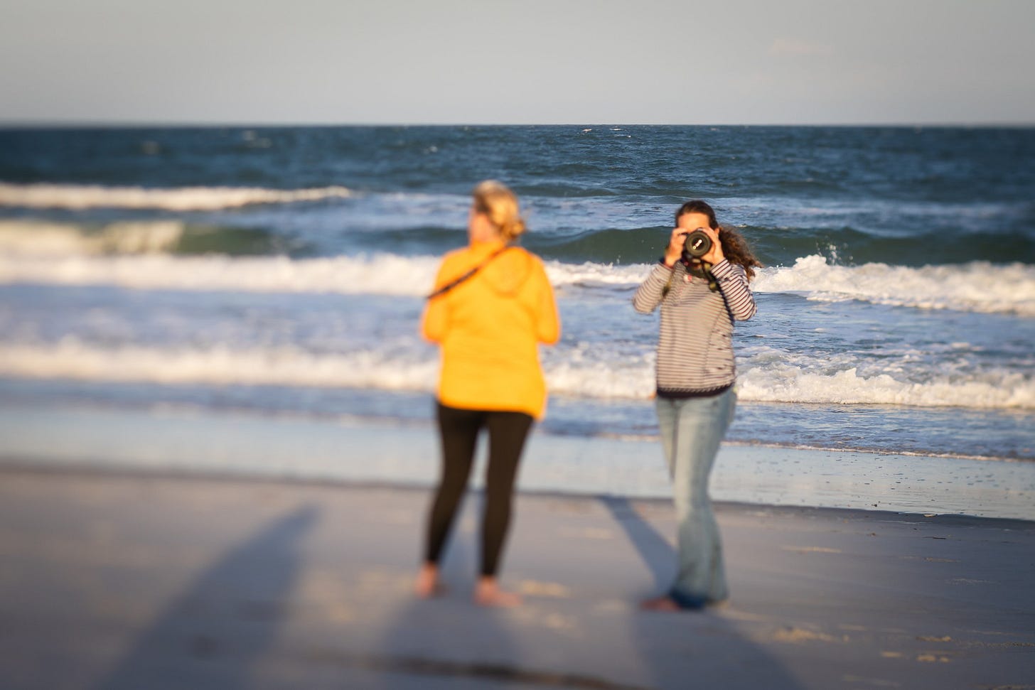 photographers on the beach with camera, figure eight island, north carolina