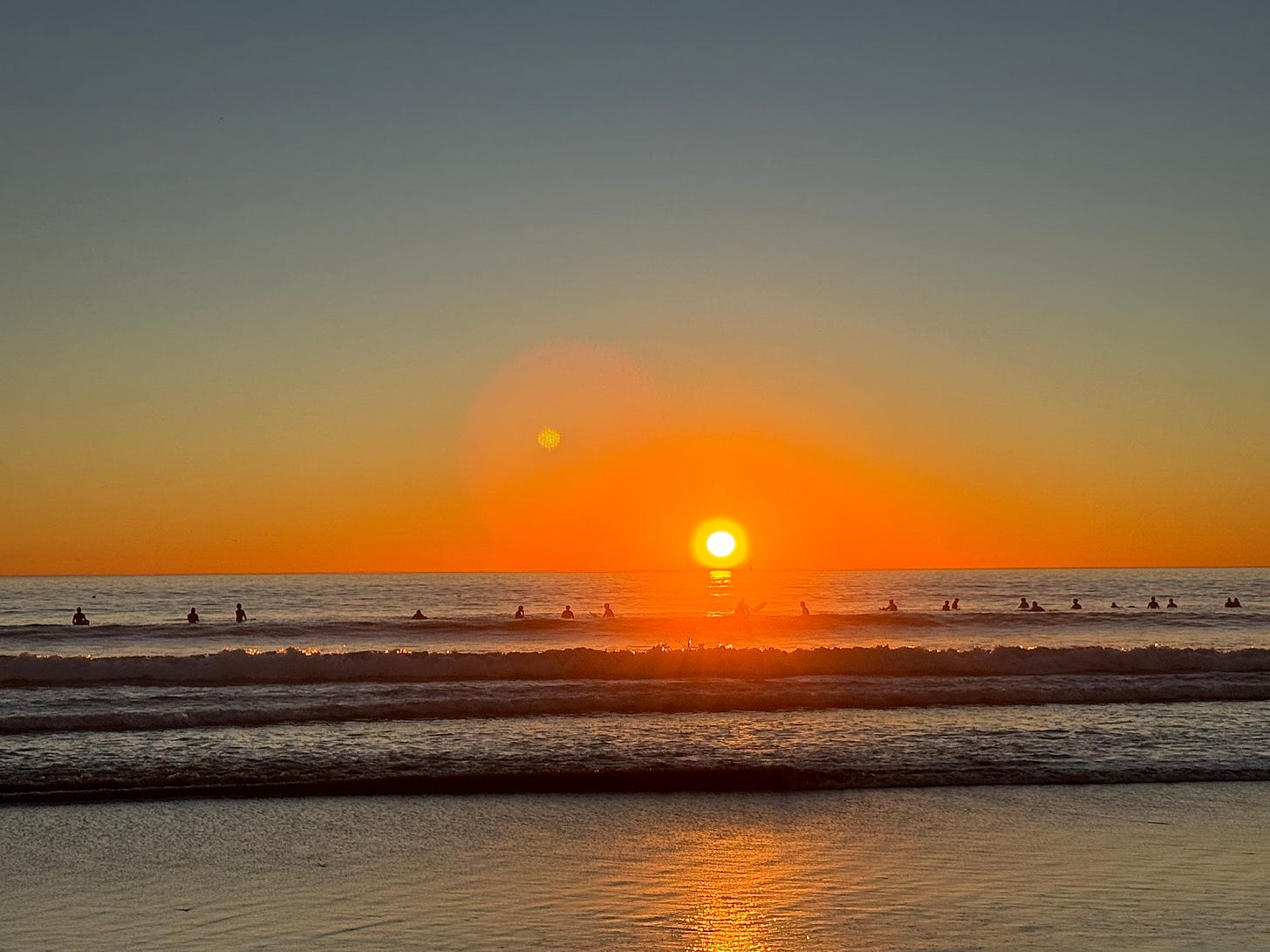 Surfers in sunset